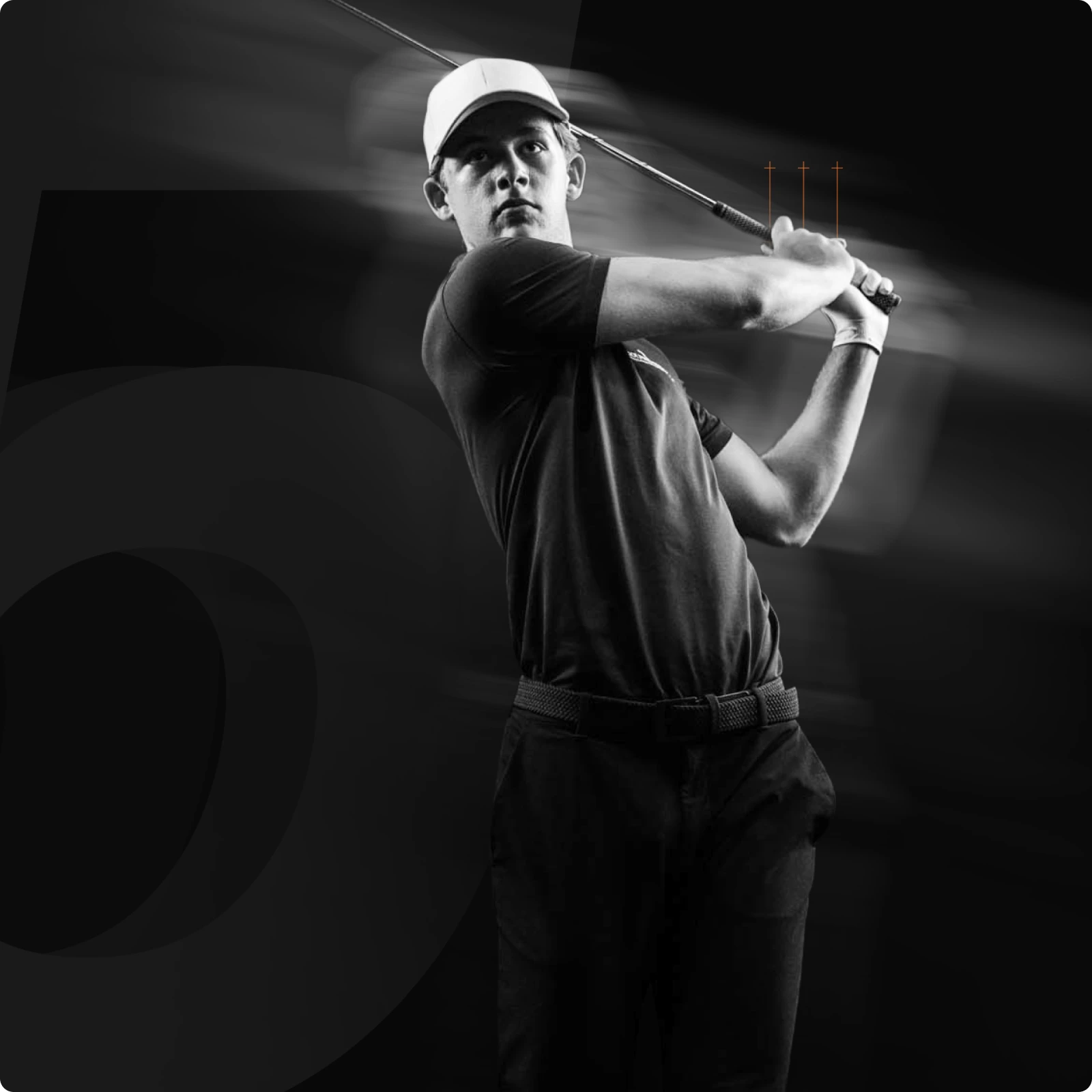 A golfer in a cap and dark attire is captured mid-swing in a black and white image, with motion blur emphasizing the dynamic action.